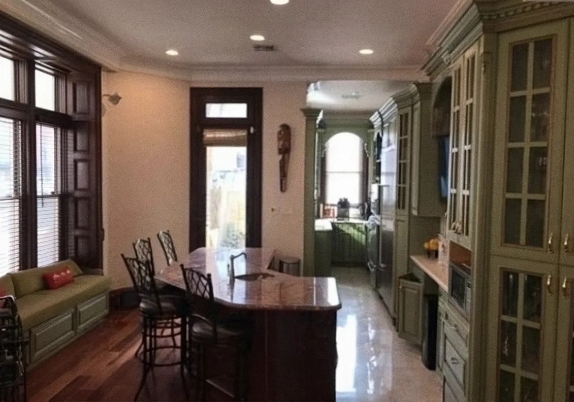 Kitchen and dining room after the remodel, with an island and hardwood floors